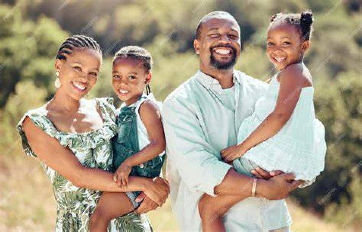 Happy young family mother, father and little daughter are sitting