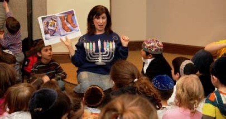 Jackie Oppenheimer reading to Hanukkah Celebration attendees.jpg